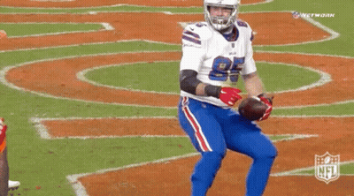 A Buffalo Bills Football Player Holds A Football In His Hands GIF
