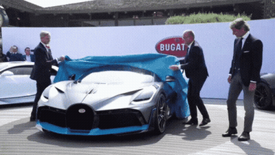 A Bugatti Car Is Covered With A Blue Tarp GIF