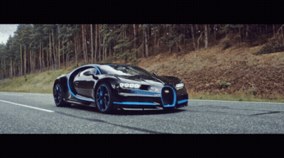 A Bugatti Chiron Is Driving Down A Road In The Woods GIF