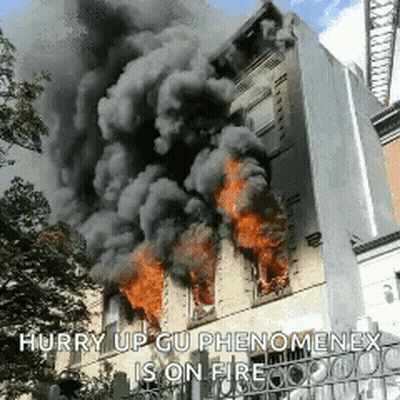 A Building Is On Fire With Smoke Coming Out Of It GIF
