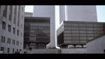 A Building With A Sign That Says No Parking GIF