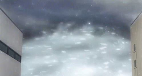 A Building With Snow Falling On It And A Dark Sky GIF