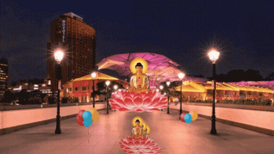 A Building With The Word Novotel On It Is Lit Up At Night GIF