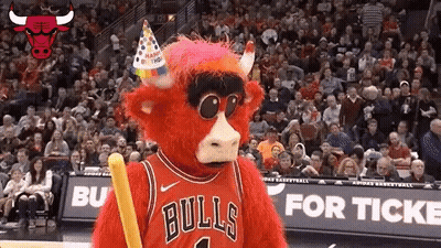 A Bulls Mascot Wearing A Birthday Hat And Holding A Stick GIF