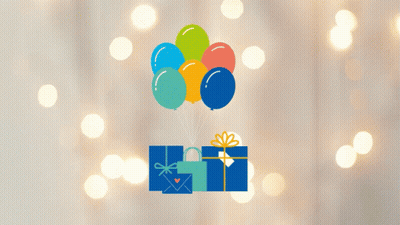 A Bunch Of Balloons Are Flying Over A Gift Box With A Heart On It GIF