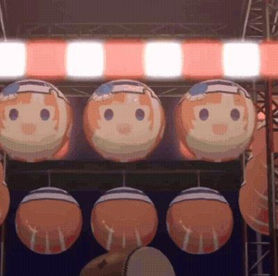 A Bunch Of Balls With Faces On Them Hanging From A Ceiling GIF