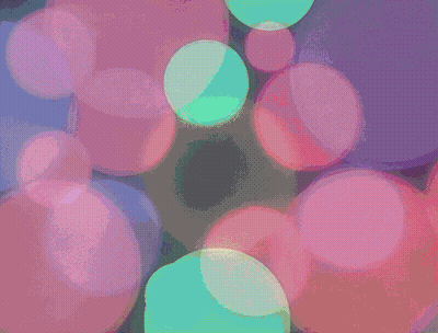 A Bunch Of Bubbles Are Floating In A Dark Room GIF