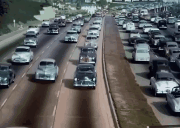 A Bunch Of Cars Are Driving Down A Road GIF