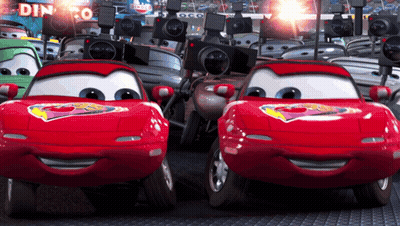 A Bunch Of Cars Are Lined Up In Front Of A Sign That Says Dinoco GIF