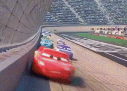 A Bunch Of Cars Are Racing On A Race Track . GIF