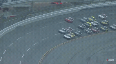 A Bunch Of Cars Are Racing On A Race Track With Nascar Written On The Bottom GIF