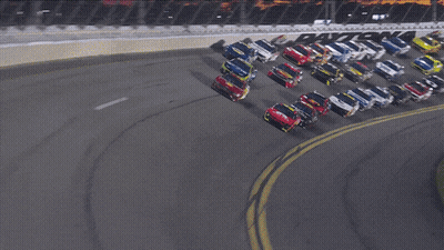 A Bunch Of Cars Are Racing On A Track With A Sign That Says ' Toyota ' GIF