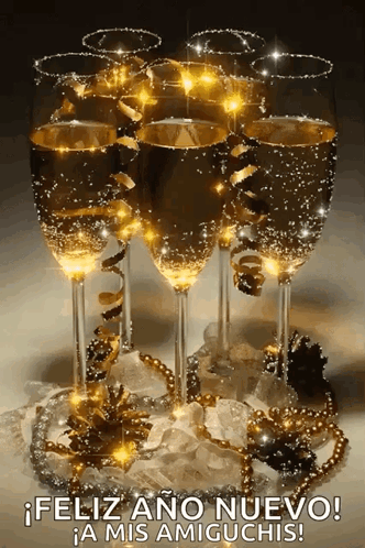 A Bunch Of Champagne Glasses With The Words Feliz Ano Nuevo A Mis Amiguchis GIF