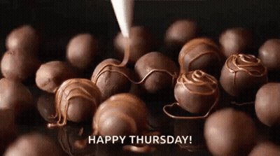 A Bunch Of Chocolate Balls Are Being Covered In Chocolate And A Happy Thursday Greeting . GIF