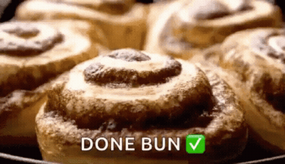 A Bunch Of Cinnamon Rolls In A Skillet With The Words `` Done Bun '' Written On It . GIF
