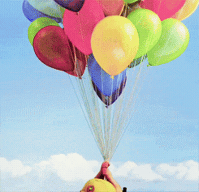 A Bunch Of Colorful Balloons Are Being Held In The Air GIF