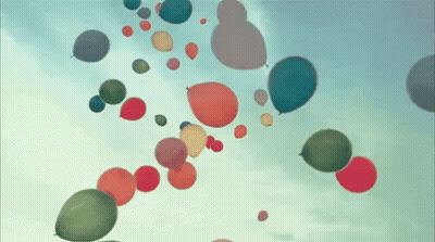 A Bunch Of Colorful Balloons Are Flying In The Air GIF