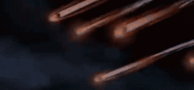 A Bunch Of Comets Are Flying Through The Night Sky GIF