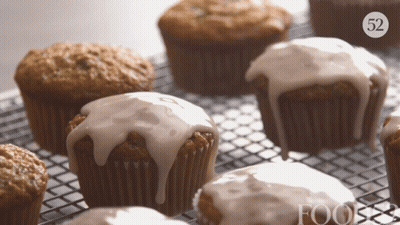 A Bunch Of Cupcakes On A Cooling Rack With The Number 52 On The Bottom Right GIF