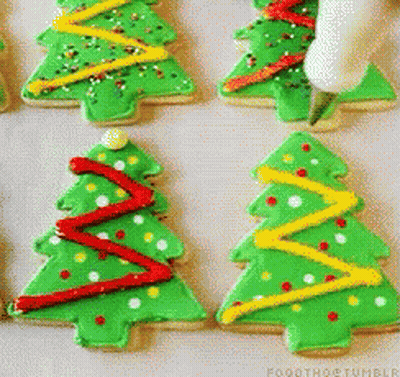 A Bunch Of Green Christmas Trees With Red Yellow And White Decorations GIF