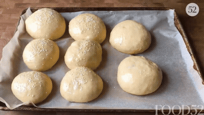 A Bunch Of Hamburger Buns On A Pan With The Number 52 GIF