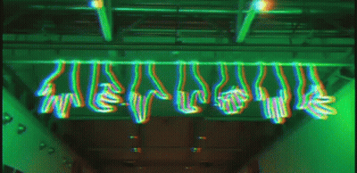 A Bunch Of Hands Are Hanging From The Ceiling In A Green Light GIF