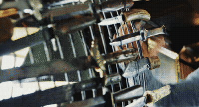 A Bunch Of Knives Are Lined Up On A Table GIF