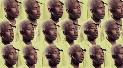 A Bunch Of Men In Yellow Shirts Are Singing Together GIF