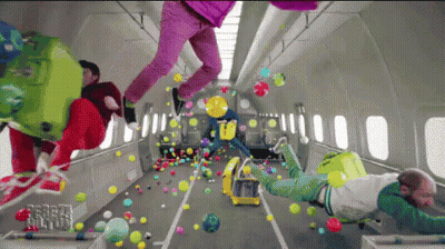 A Bunch Of People Are Flying Through The Air With Balloons And Luggage GIF
