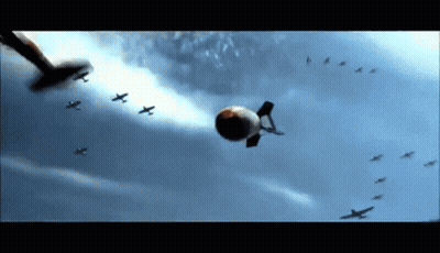 A Bunch Of Planes Are Flying In The Sky With A Bomb Flying In The Middle GIF