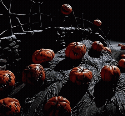 A Bunch Of Pumpkins And Ghosts Are On A Tree Trunk GIF