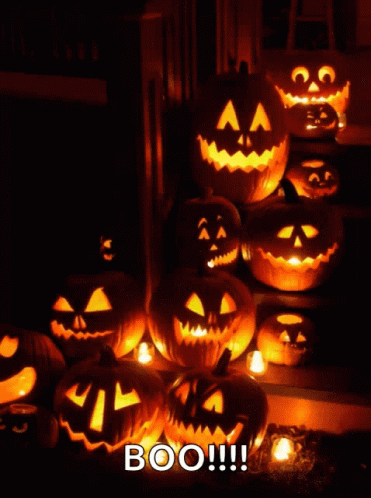 A Bunch Of Pumpkins Are Lit Up With The Words Boo GIF