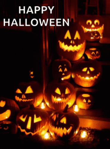 A Bunch Of Pumpkins Are Lit Up With The Words Happy Halloween Written Above Them GIF