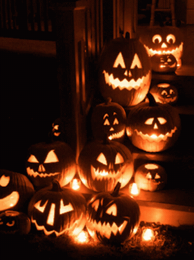 A Bunch Of Pumpkins With Faces Carved On Them GIF