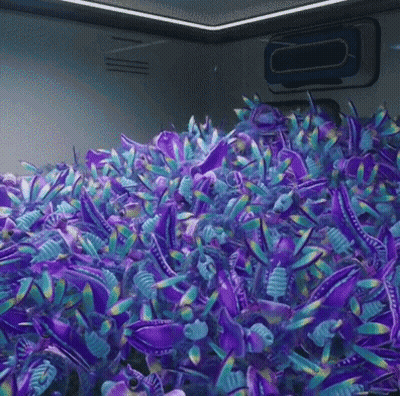 A Bunch Of Purple And Blue Stuffed Animals Are Sitting On Top Of Each Other . GIF