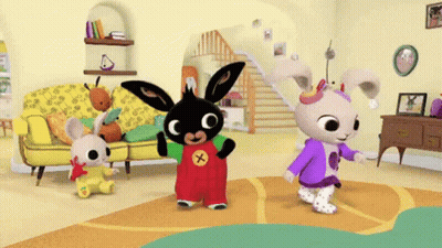 A Bunch Of Rabbits Are Dancing In A Living Room With A Yellow Couch GIF