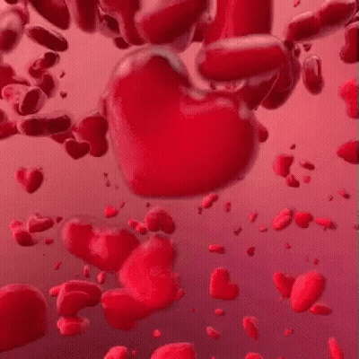 A Bunch Of Red Hearts Are Floating In The Air On A Pink Background . GIF