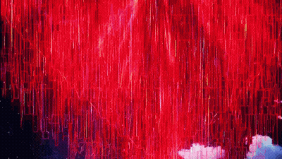 A Bunch Of Red Lights Are Coming Out Of The Sky GIF