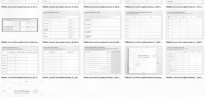 A Bunch Of Sheets Of Paper With Numbers On Them Are Lined Up On A Table . GIF