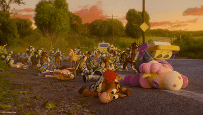A Bunch Of Stuffed Animals Are Laying On The Side Of A Road GIF