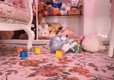 A Bunch Of Stuffed Animals Are On The Floor Including A Stuffed Unicorn GIF