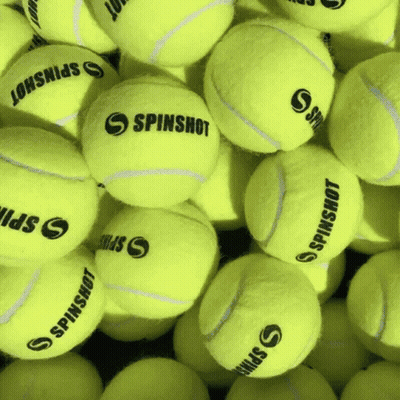 A Bunch Of Tennis Balls With Spinshot On Them GIF