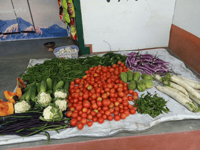 A Bunch Of Vegetables On A Table With A Sign Behind Them That Says Jeaerselfie GIF