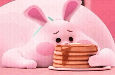 A Bunny Is Eating A Stack Of Pancakes With Syrup . GIF