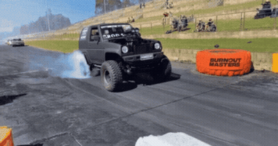 A Burnout Masters Bag Is On The Side Of A Road GIF