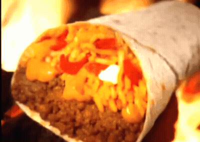 A Burrito With A Lot Of Toppings Including Cheese And Meat GIF