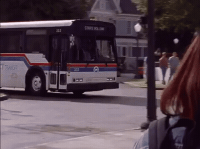 A Bus That Says Stars Hollow Is Driving Down The Street GIF