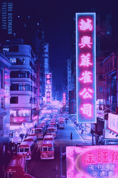 A Busy City Street With A Neon Sign That Says Jorge Dickmann GIF