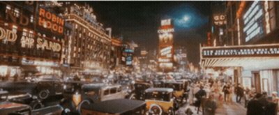 A Busy City Street With A Robin Hood Sign GIF