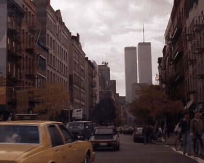 A Busy City Street With A Taxi That Says Nyc Taxi On The Side GIF